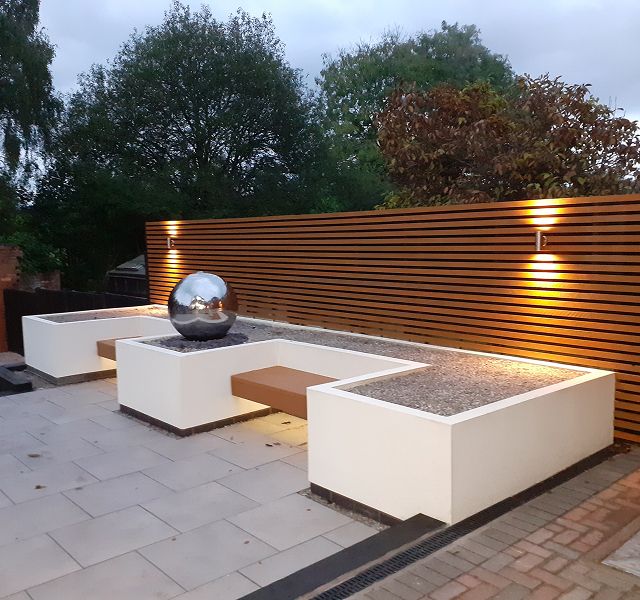 Completed garden landscaping project with outdoor lighting