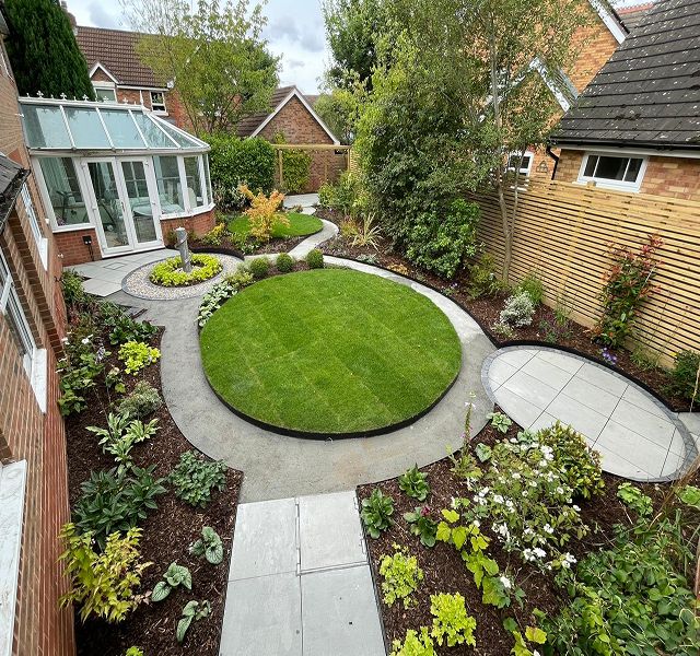 Completed garden landscaping project with lawn and patio