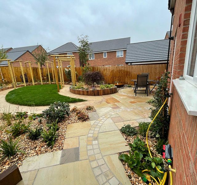 Completed garden landscaping project with lawn and patio