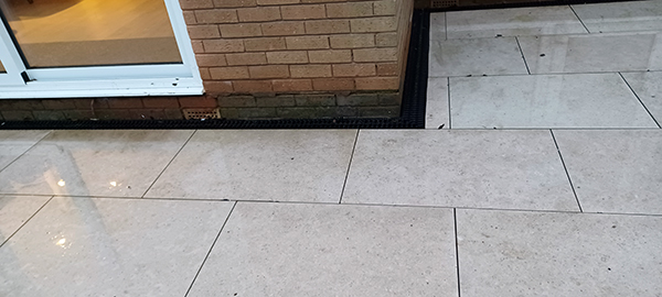 Waterlogged Garden from Rain Overflowed onto a Patio Area Very Close to the House Brickwork